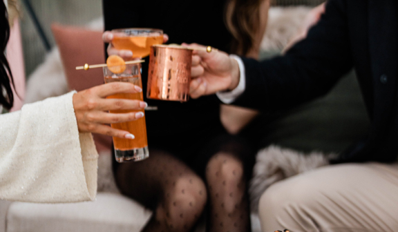 group cheering over a cheese board in a ski hut