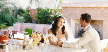 wedding couple sitting at the hotel bar