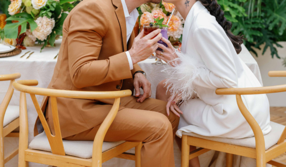 Couple kissing at wedding table
