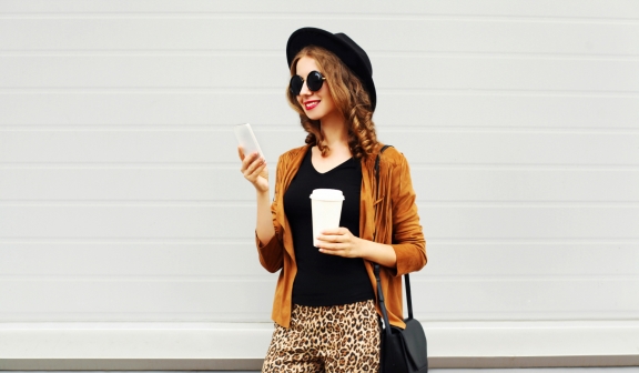 Stylish woman looking at her cell phone