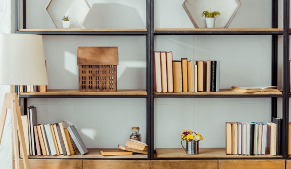 Wooden shelf with booking, boxes and candles