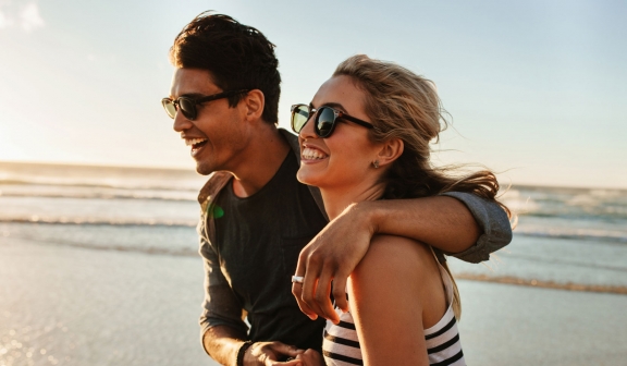 Couple on the beach laughing