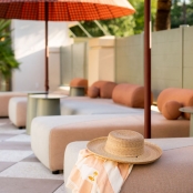 Closeup of a straw hat placed on a pool lounge chair
