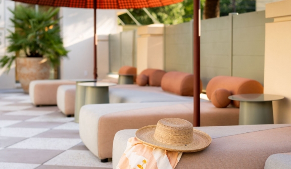 Closeup of a straw hat placed on a pool lounge chair