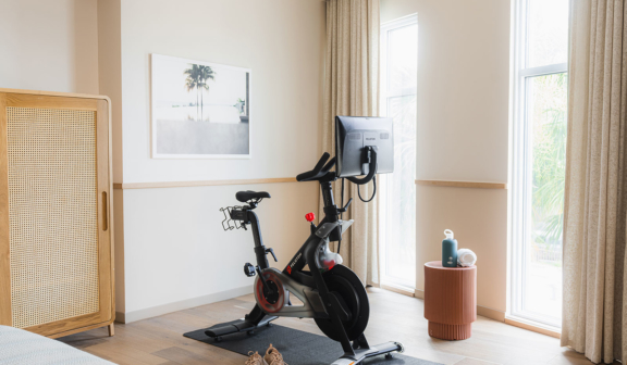 Exercise bike and workout gear in guest room