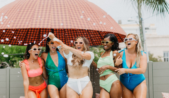 Friends having champagne poolsite