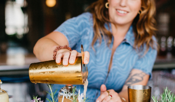 A bartender pouring cocktails