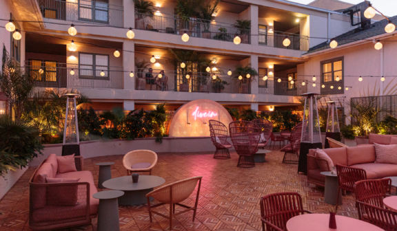 outdoor courtyard with tables chairs and a fireplace