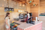 woman making purchase from man behind coffee counter