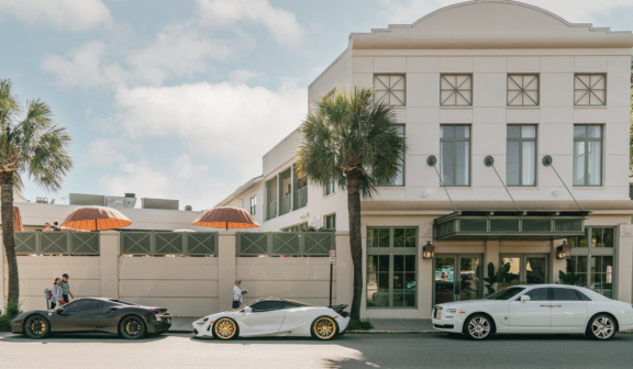 expensive cars parked in street outside hotel