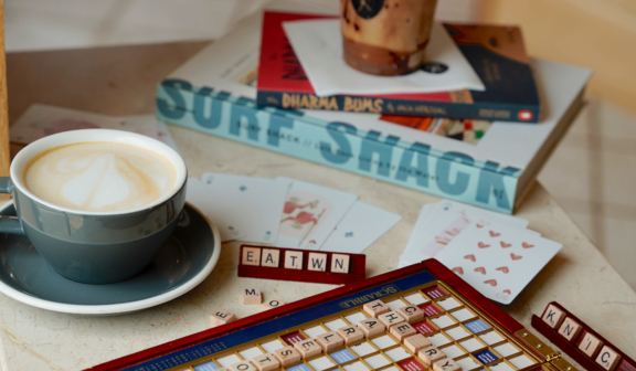 scrabble on table with coffee and books