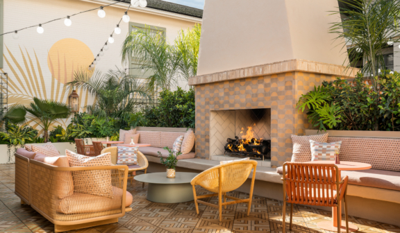 Outdoor seating area with fireplace and warm colored patio furniture