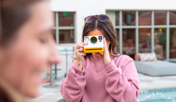 woman using polaroid camera
