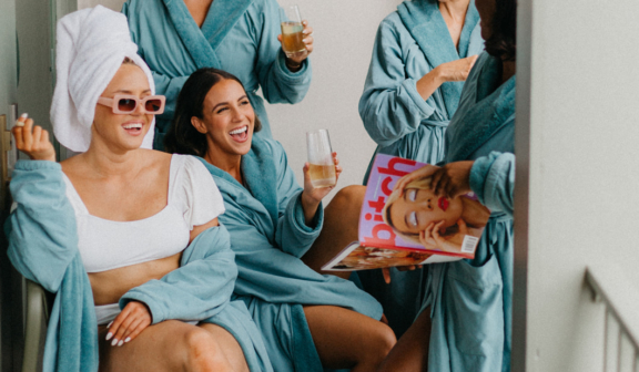 five women in robes having a great time