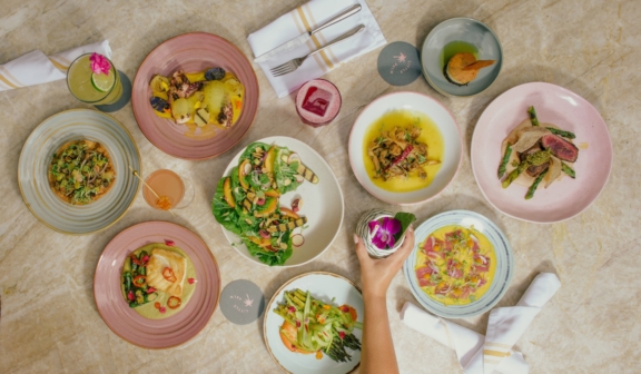 view from overhead of various plates of food and cocktails on a table