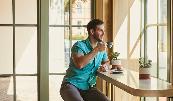 man drinking coffee in lobby