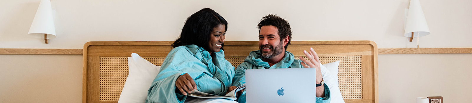 couple in bed with computer
