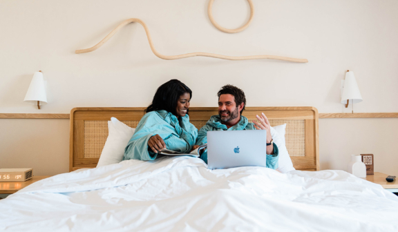couple in bed with computer
