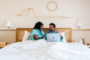couple in bed with computer