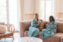 two girls on sofa in palm suite in robes